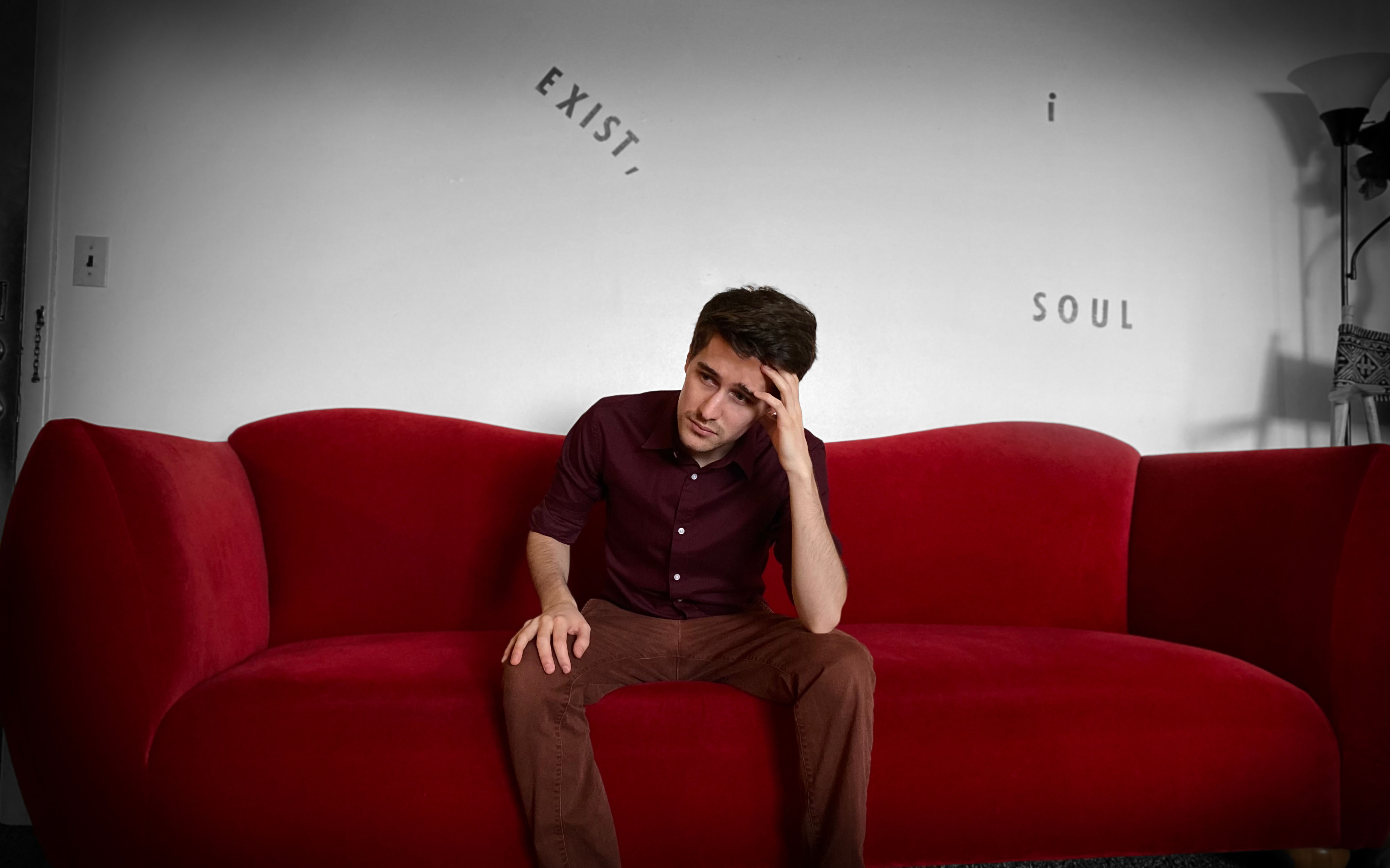 Stephen Karukas having an existential crisis on a couch